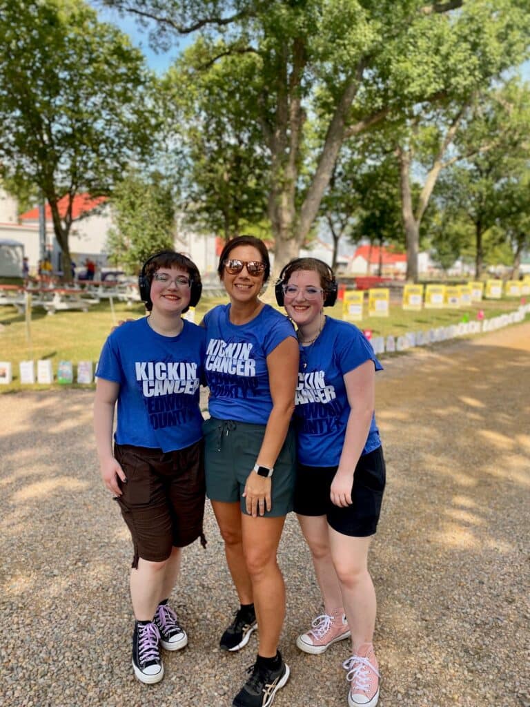Three women in blue t-shirts at the 3rd Annual Kickin' Cancer Event